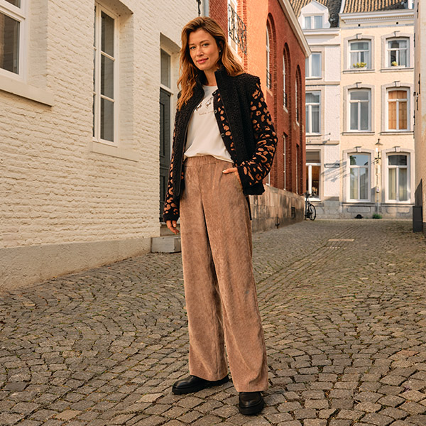 Weibliches Model mit locker geschnittener Hose in Beige